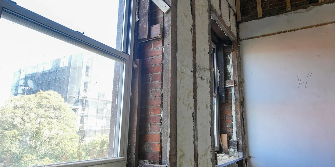 Insulated wall and window opening in a building envelope under construction