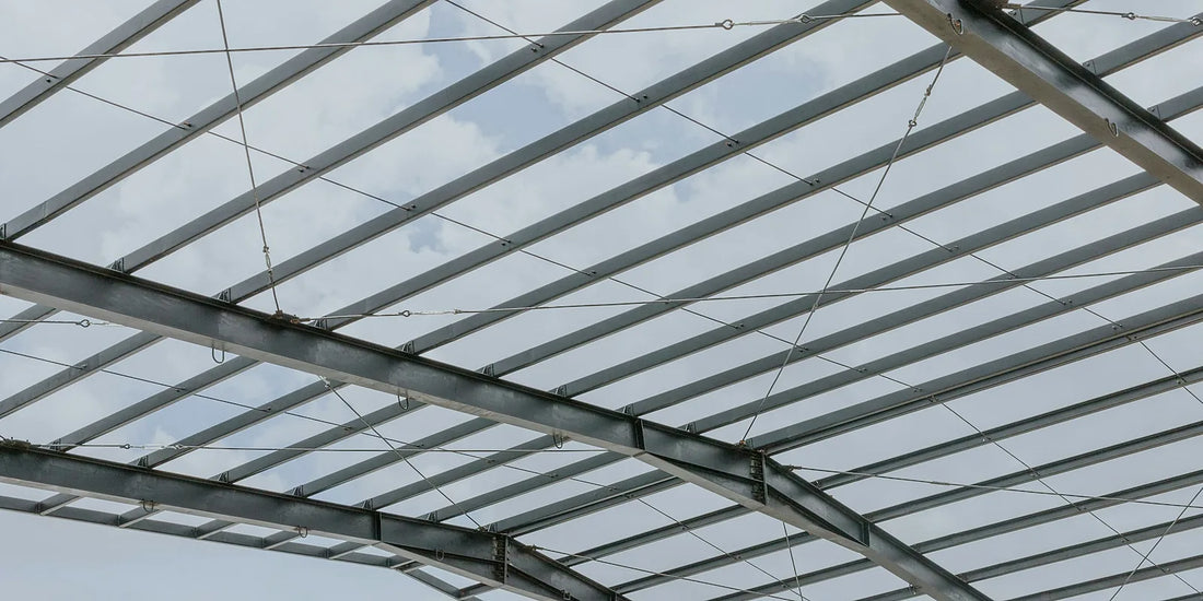 Steel purlins running across a portal frame roof before the sheeting goes on