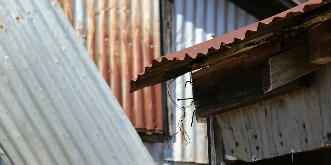Corroded corrugated metal roof sheeting and eaves on an older building
