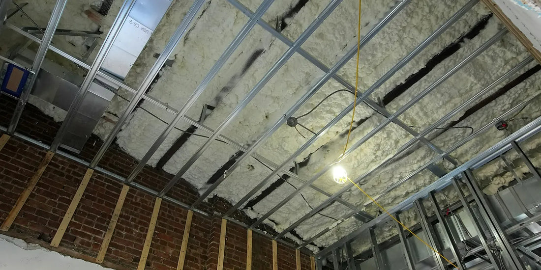 Ceiling under construction with insulation fitted between the framing before lining
