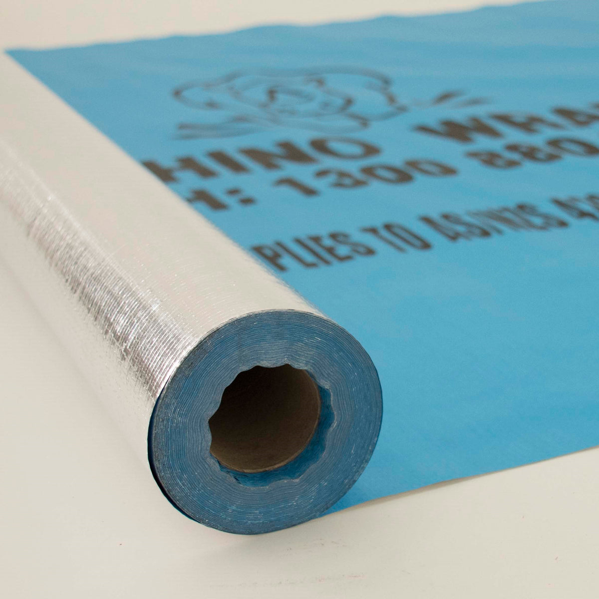 Rhino Wrap roll partly unrolled, showing the foil face and the light blue printed face