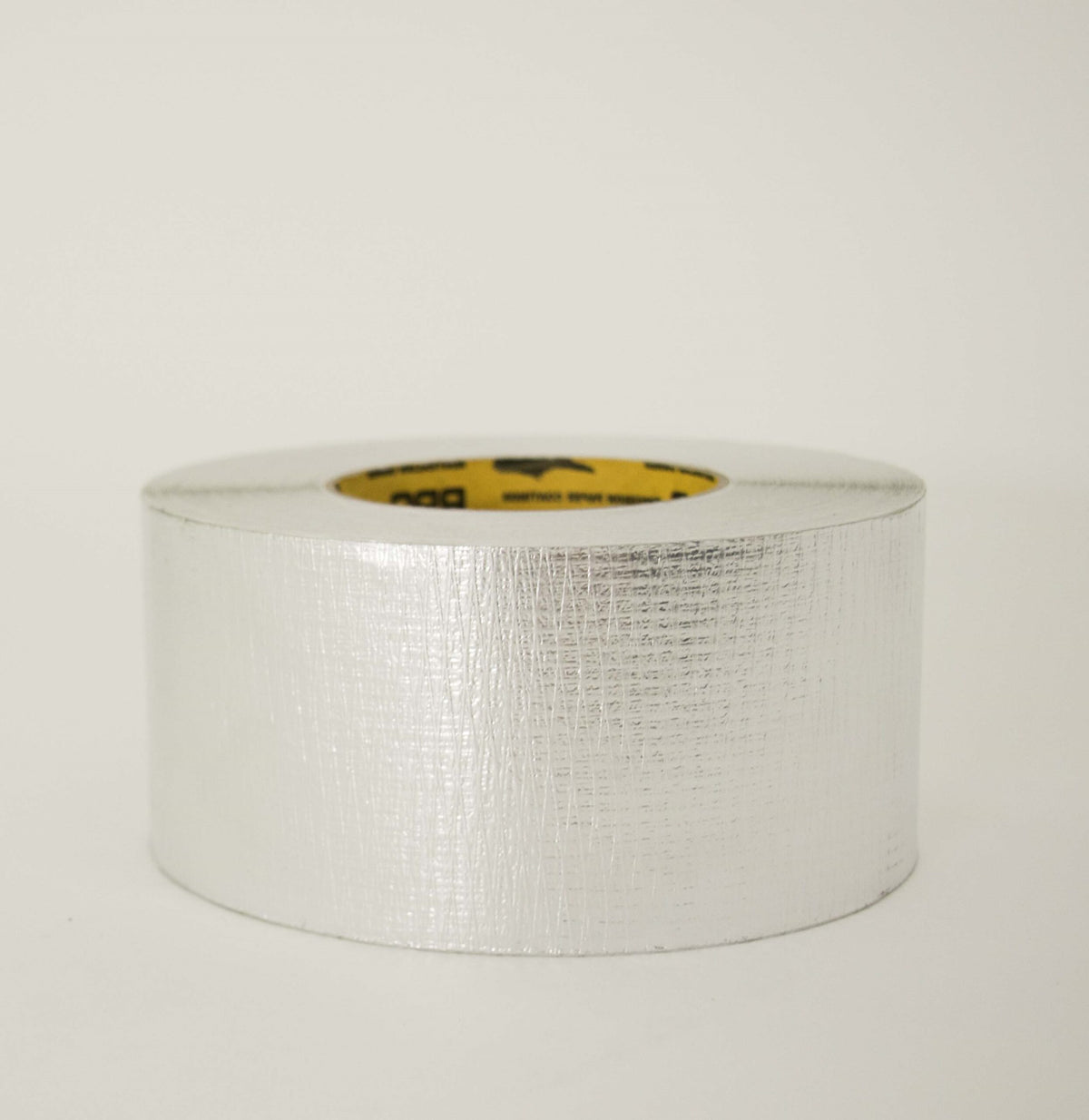 Rhino Reinforced Foil Tape roll lying flat, silver foil with the reinforcing mesh pattern showing through